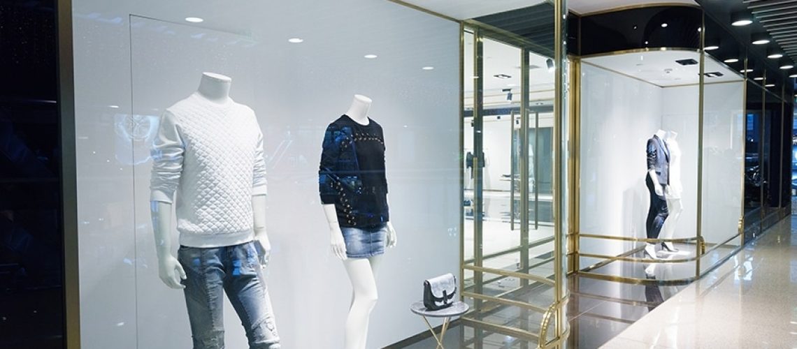 frameless glass shop front with mannequins